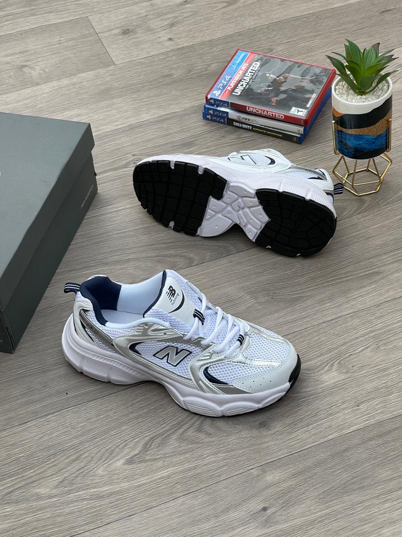 12cbd2da-269d-4bbb-86ce-418a5f7ea9db New Balance 530 Sneakers in White and Silver | Available at Arvoluxury - Image 1