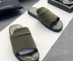 A pair of olive green ribbed double strap slide sandals on a white surface, showcasing the comfort and style of ArvoLuxury's premium footwear.