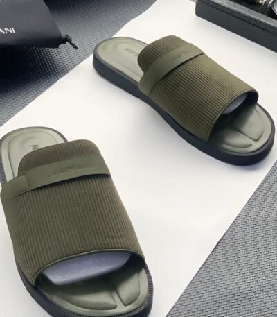 A pair of olive green ribbed double strap slide sandals on a white surface, showcasing the comfort and style of ArvoLuxury's premium footwear.