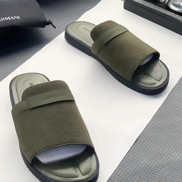 A pair of olive green ribbed double strap slide sandals on a white surface, showcasing the comfort and style of ArvoLuxury's premium footwear.