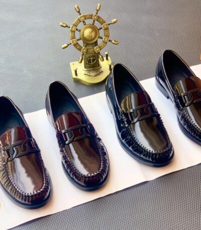 A stylish display of four black leather loafers with double buckle details, showcasing exceptional craftsmanship and luxury design.