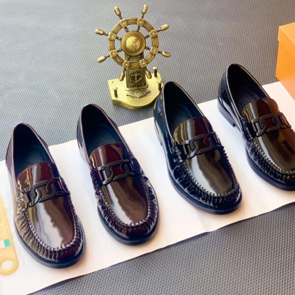 A stylish display of four black leather loafers with double buckle details, showcasing exceptional craftsmanship and luxury design.