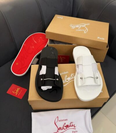 Luxury Christian Louboutin Paris slide sandals in black and white, displayed with box and accessories.