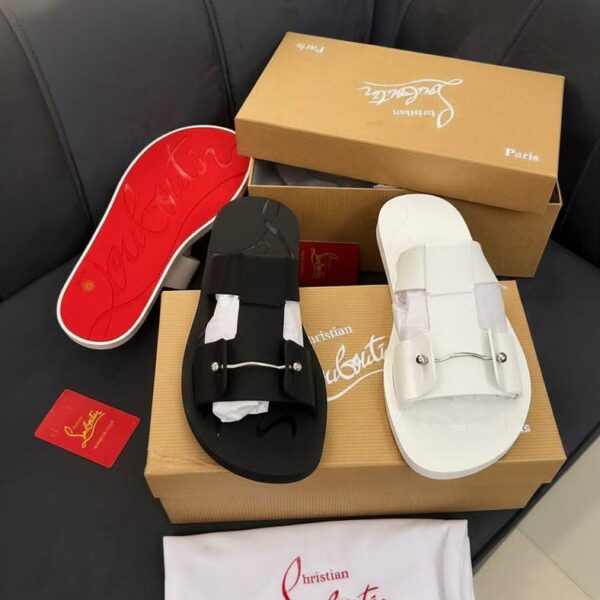 Luxury Christian Louboutin Paris slide sandals in black and white, displayed with box and accessories.