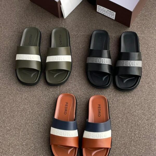 A display of three pairs of Pedro two-strap slide sandals in olive green, black, and terracotta, with their respective shoe boxes.
