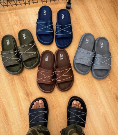 A collection of high-end slides in various colors, including black, navy blue, brown, and grey, showcasing exceptional craftsmanship and comfort.