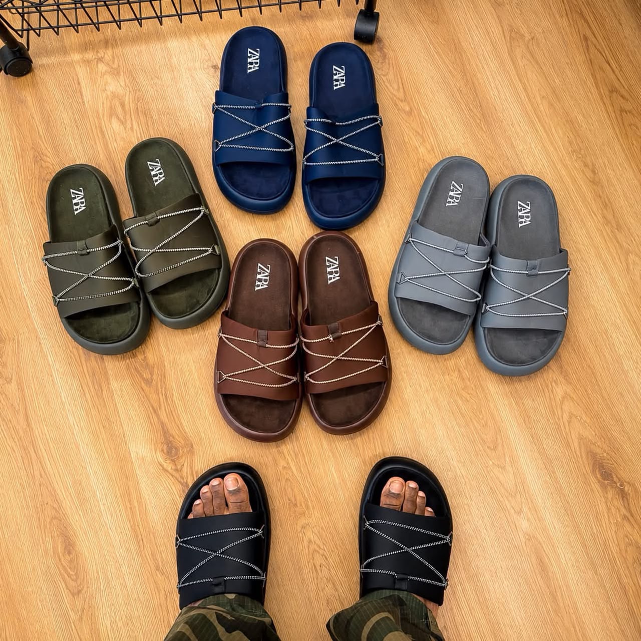 root A collection of high-end slides in various colors, including black, navy blue, brown, and grey, showcasing exceptional craftsmanship and comfort.