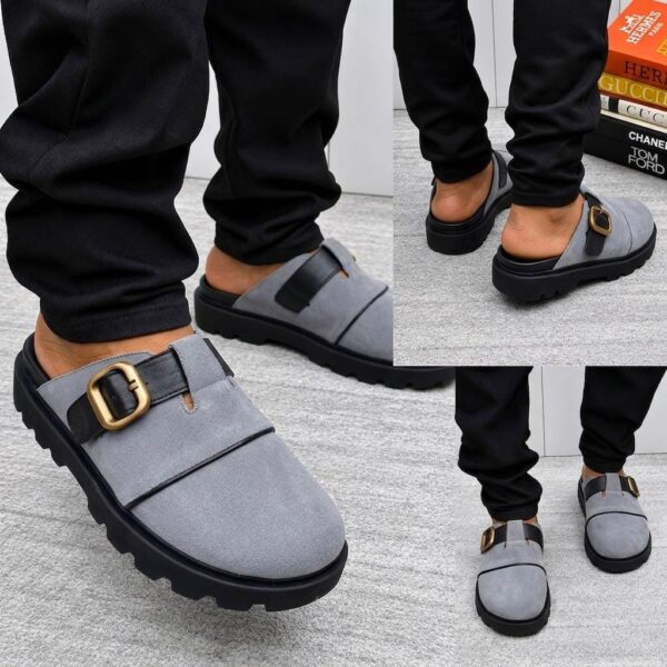 A stylish pair of grey loafers with a gold buckle and black sole, perfect for making a lasting impression.