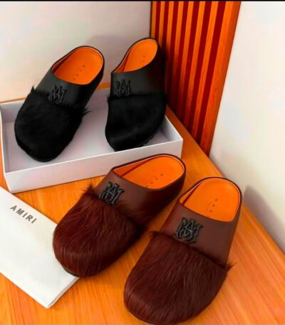 A pair of luxurious fur-trimmed half shoes in black and brown, showcasing the premium materials and attention to detail.