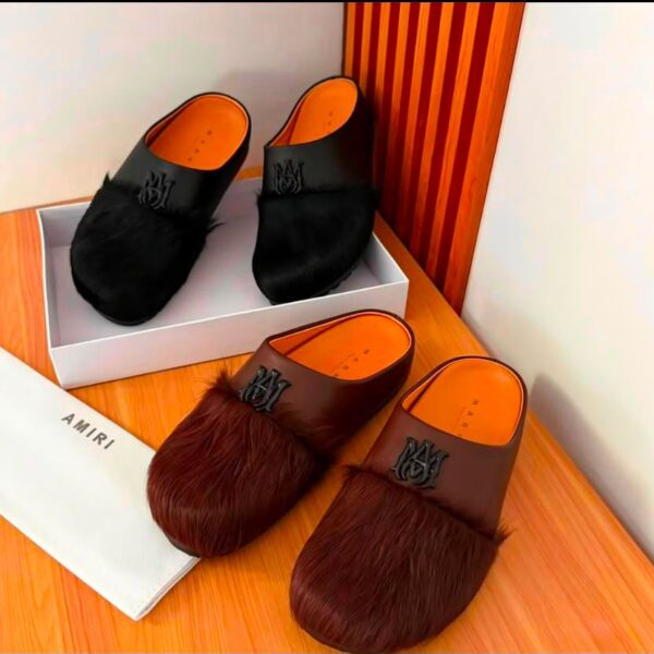 A pair of luxurious fur-trimmed half shoes in black and brown, showcasing the premium materials and attention to detail.