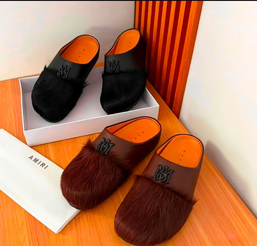 root A pair of luxurious fur-trimmed half shoes in black and brown, showcasing the premium materials and attention to detail.
