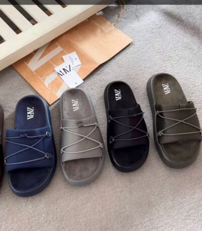 A collection of high-end slides in various colors, including black, navy blue, brown, and grey, showcasing exceptional craftsmanship and comfort.