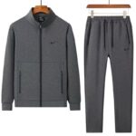 A stylish grey tracksuit comprising a zip-up jacket and matching joggers, perfect for making a statement.